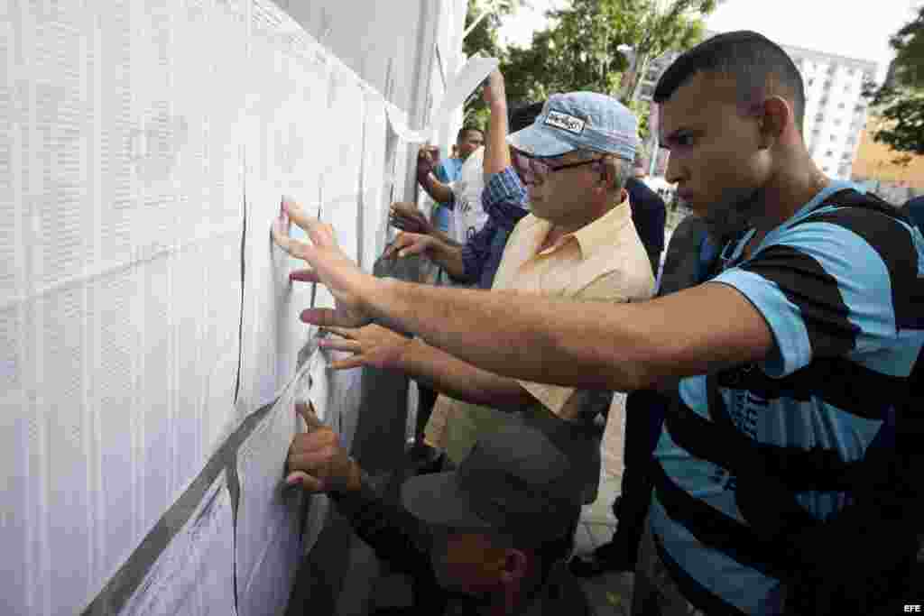 Un grupo de personas busca sus datos personales para ejercer el derecho al voto hoy 6 de diciembre del 2015 en la ciudad de Caracas.